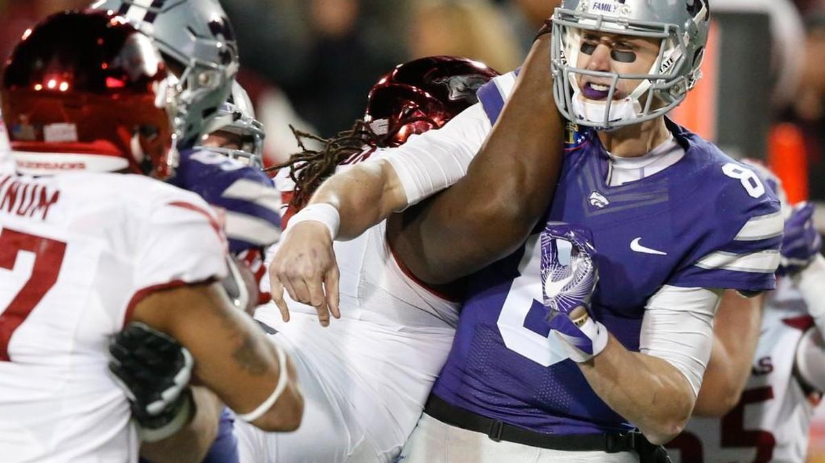 K-State quarterback Joe Hubener is hit hard after he gets off his only play in the Liberty Bowl on Saturday. It resulted in an interception.