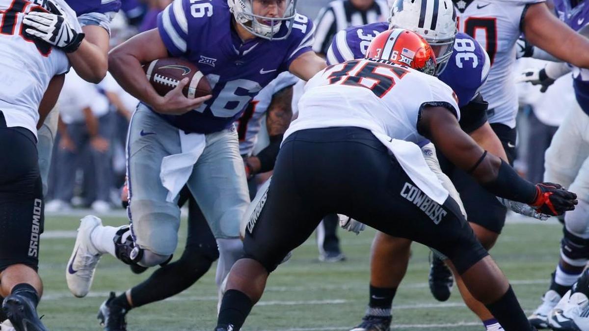 K-State quarterback Jesse Ertz looks for a hole as he heads to the end zone Saturday afternoon as K-State took on Oklahoma State in Manhattan. (November 5, 2016)