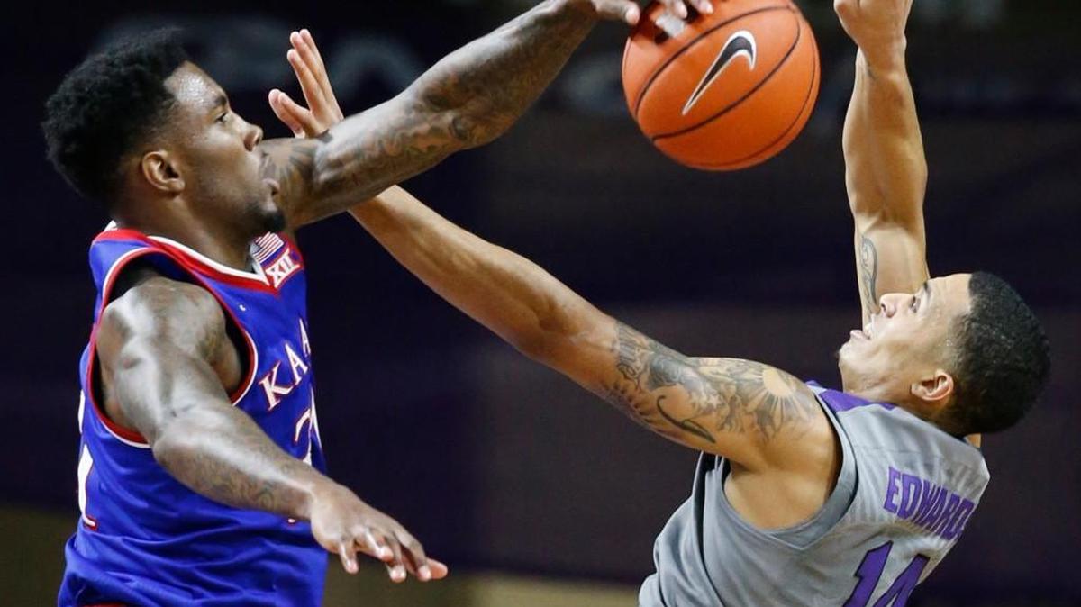 Kansas forward Jamari Traylor knocks down a shot by K-State guard Justin Edwards late in the first half Saturday in Bramlage Coliseum.(February 20, 2016)