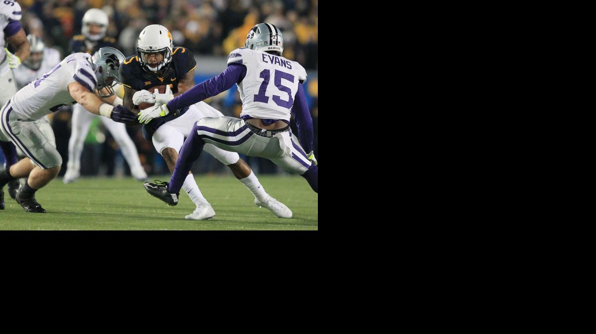 
West Virginia's Mario Alford is tackled by Kansas State's Jonathan Truman, left, and Randall Evans during the first half Thursday in Morgantown, W.Va.
