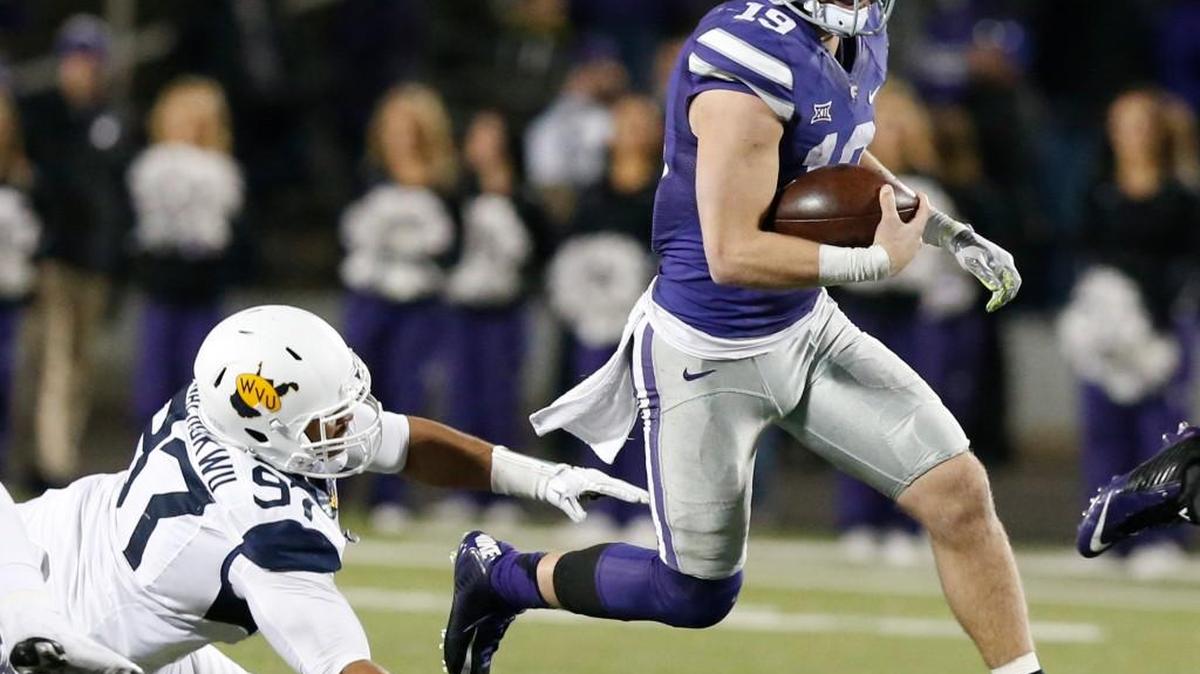 Kody Cook slips past West Virginia defensive lineman Noble Nwachukwu on Dec. 5. Inserted into the game at QB, Cook played well and may be in the mix to start the Liberty Bowl under center.