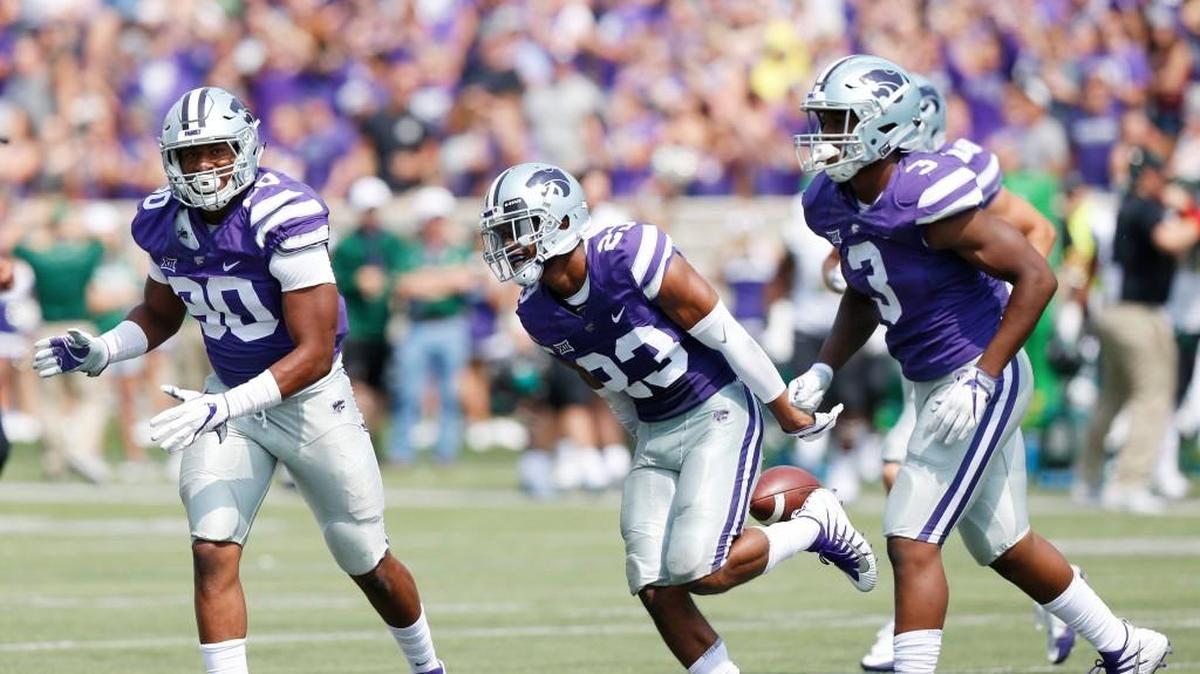 K-State defensive back Cre Moore (23) celebrates after snagging a deflected pass from Charlotte quarterback Brooks Barden (12) in the second half Saturday. (September 9, 2017)
