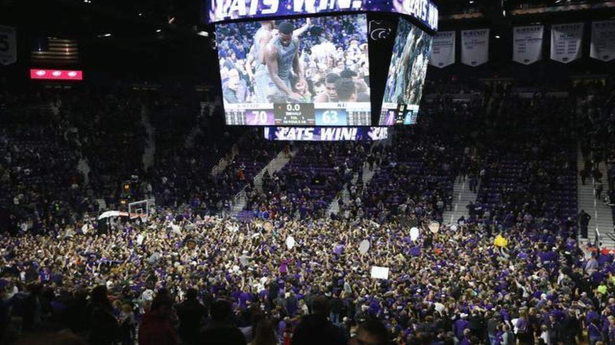 
Kansas State fans cover the court Monday night in Manhattan following K-State’s win over Kansas.
