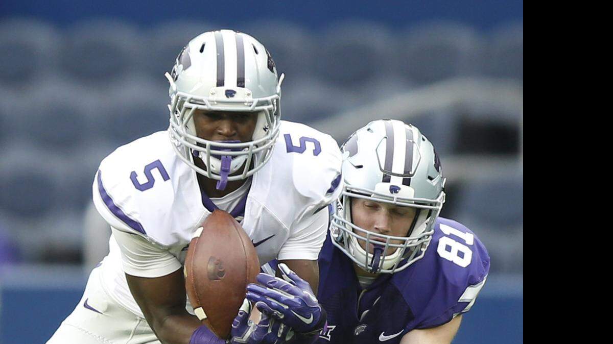 
Jesse Mack intercepts a pass intended for Kyle Klein during the first half on Kansas State’s spring game Saturday at Sporting Park in Kansas City, Kan. Mack scored on the play.
