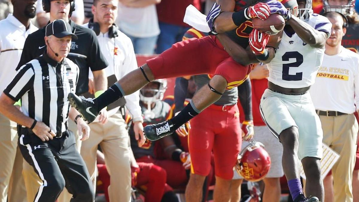 Iowa State wide receiver Carson Epps, left, makes a catch over Kansas State defensive back DJ Reed during the second half Saturday.