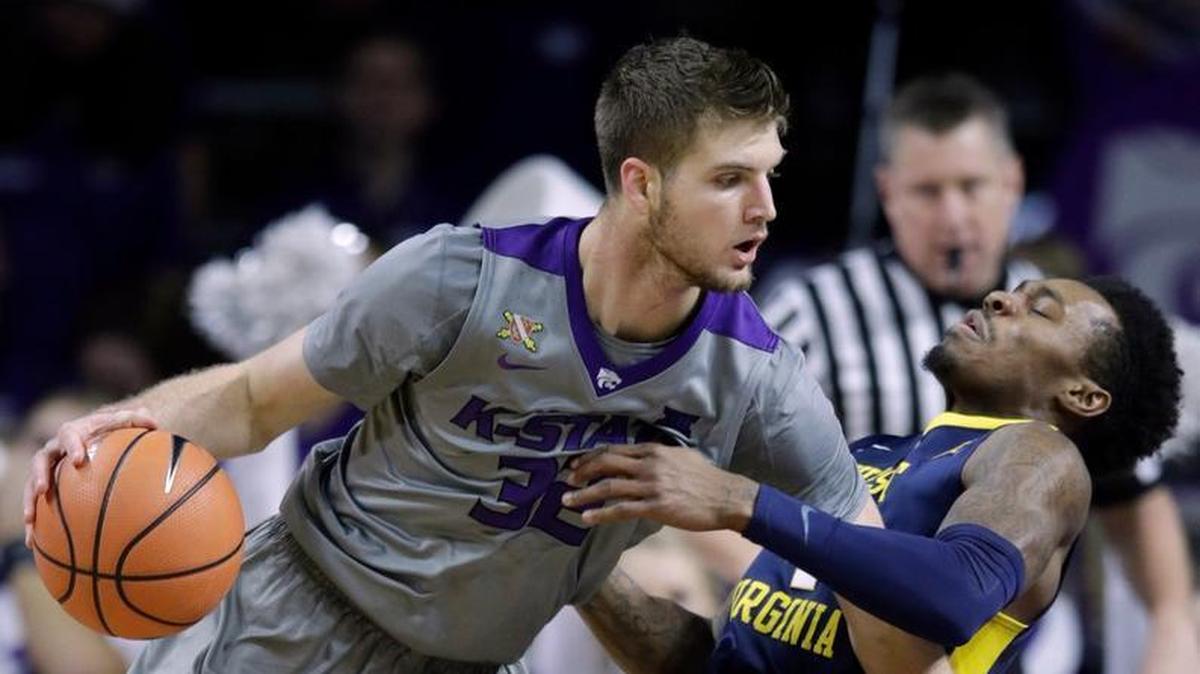 Kansas State forward Dean Wade runs into West Virginia guard Daxter Miles Jr. during the first half Monday in Manhattan.