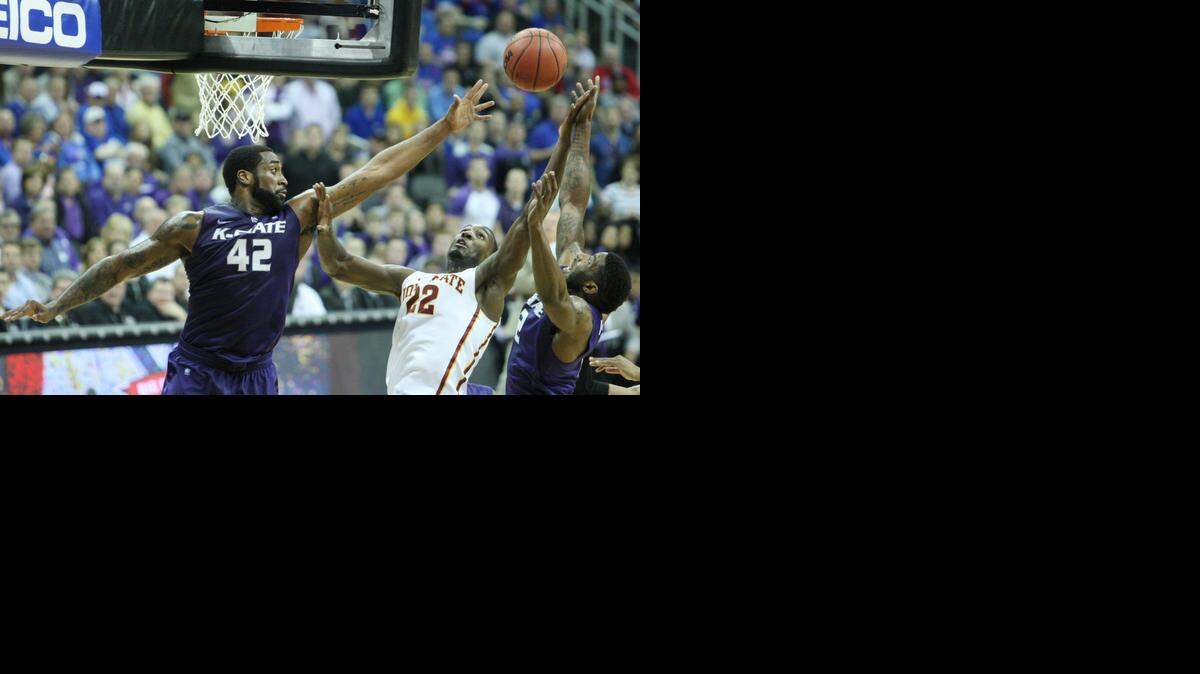 
K-State forward Thomas Gipson reaches for the ball as Iowa State forward Dustin Hogue tries to grab a rebound under the basket during the 2014 Big 12 Tournament. The teams face off with first place on the line Tuesday in Ames, Iowa.

