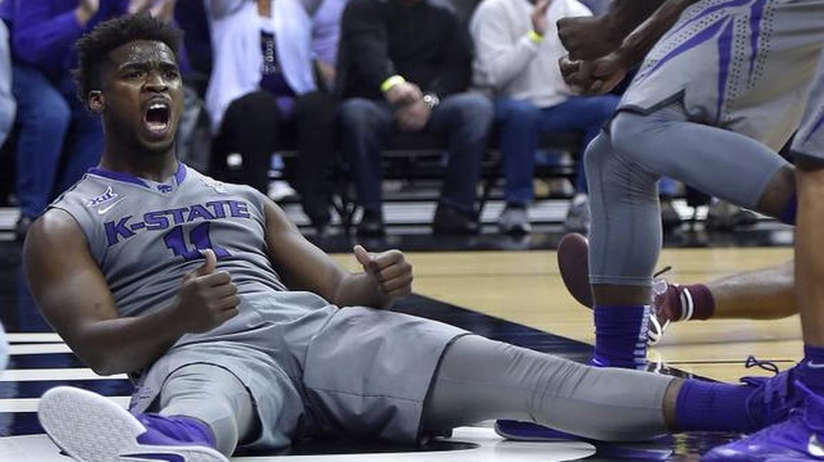 
Kansas State's Nino Williams celebrates from the floor after scoring on a drive while being fouled during the first half Saturday at the Sprint Center in Kansas City, Mo. 
