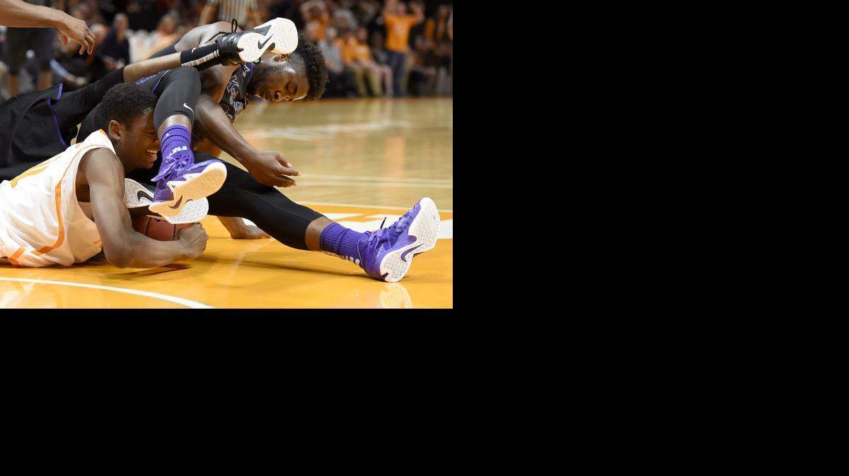 
Tennessee forward Tariq Owens scrambles for the ball with Kansas State forward Nino Williams Saturday during the Volunteers’ 65-64 victory.

