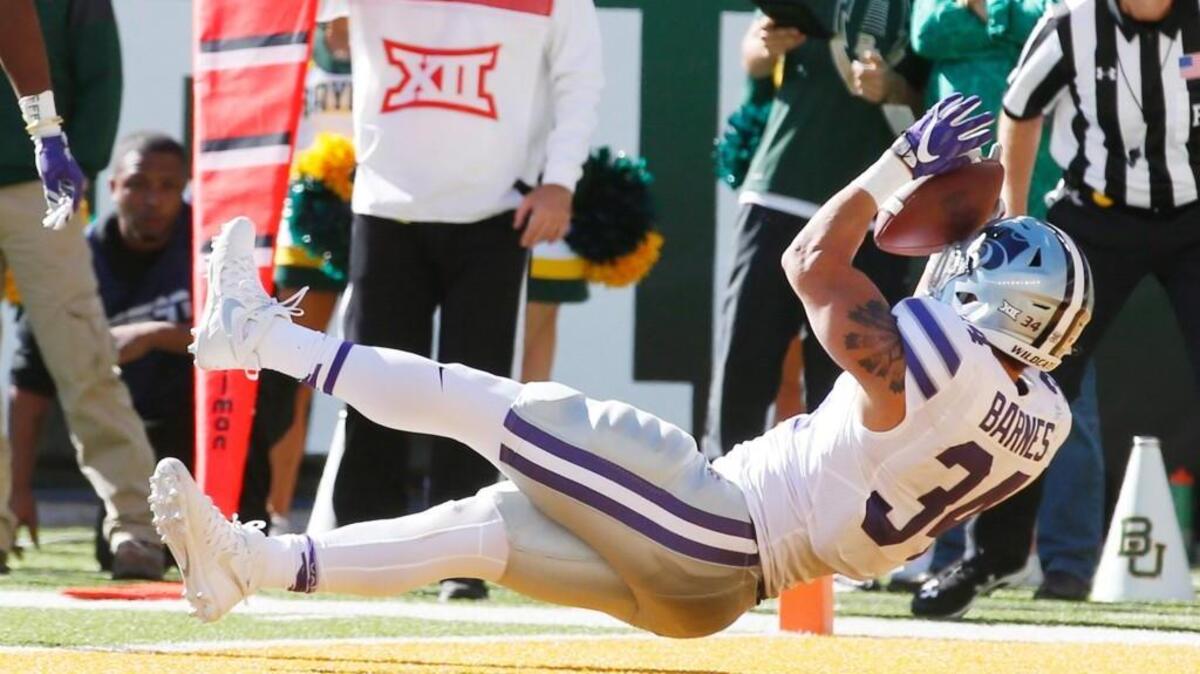 K-State running back Alex Barnes (34) dives backwards into the end zone Saturday on one of his four touchdowns against Baylor.