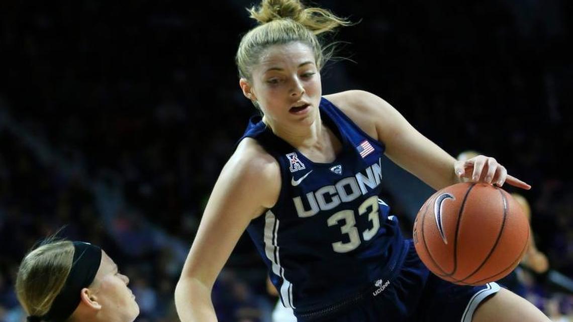 Connecticut forward Katie Lou Samuelson (33) charges into Kansas State guard Shaelyn Martin (50) during the first half Sunday in Manhattan.