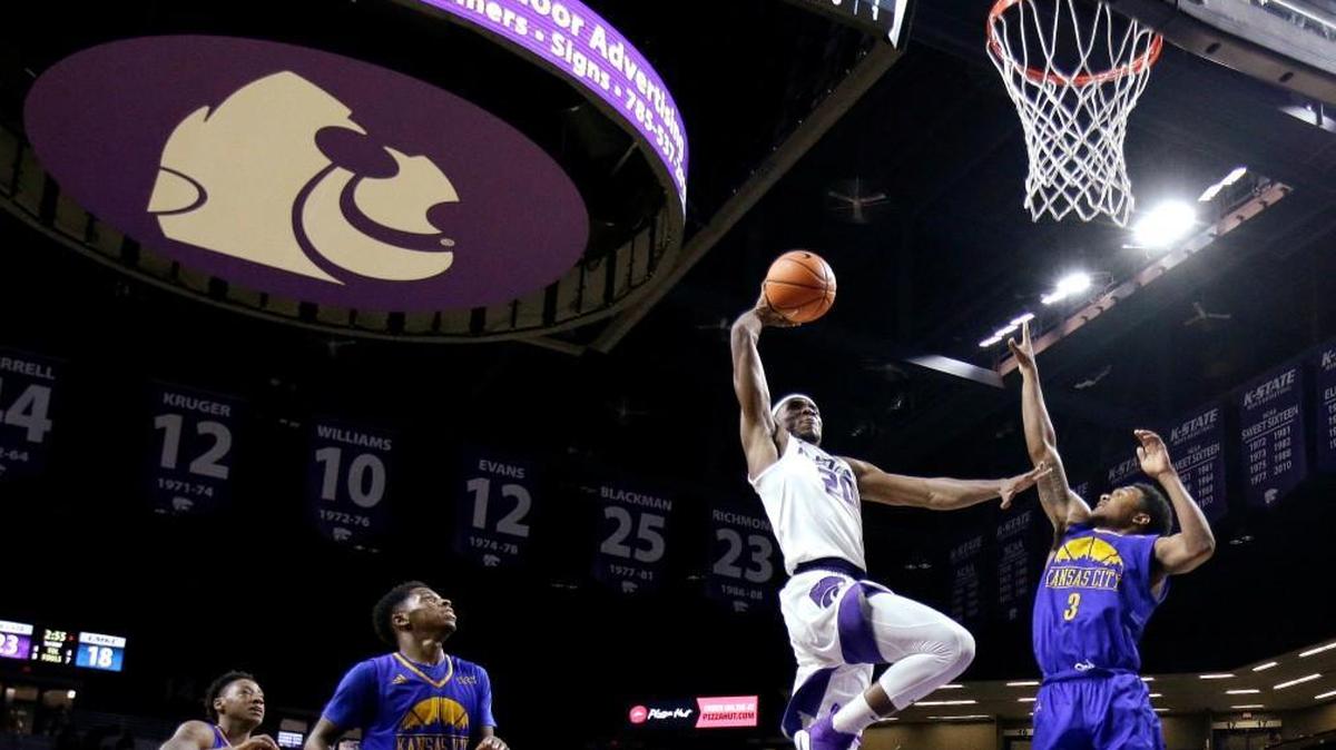 Kansas State's Xavier Sneed gets past UKMC's Brandon McKissic for a dunk during the first half Tuesday night in Manhattan.