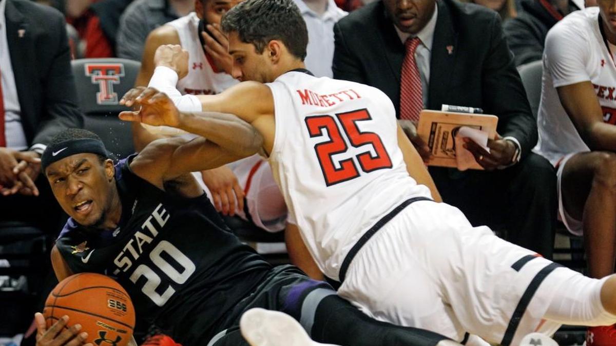Kansas State's Xavier Sneed (20) and Texas Tech's Davide Moretti (25) fall down trying to grab the ball during the second half Saturday in Lubbock, Texas.