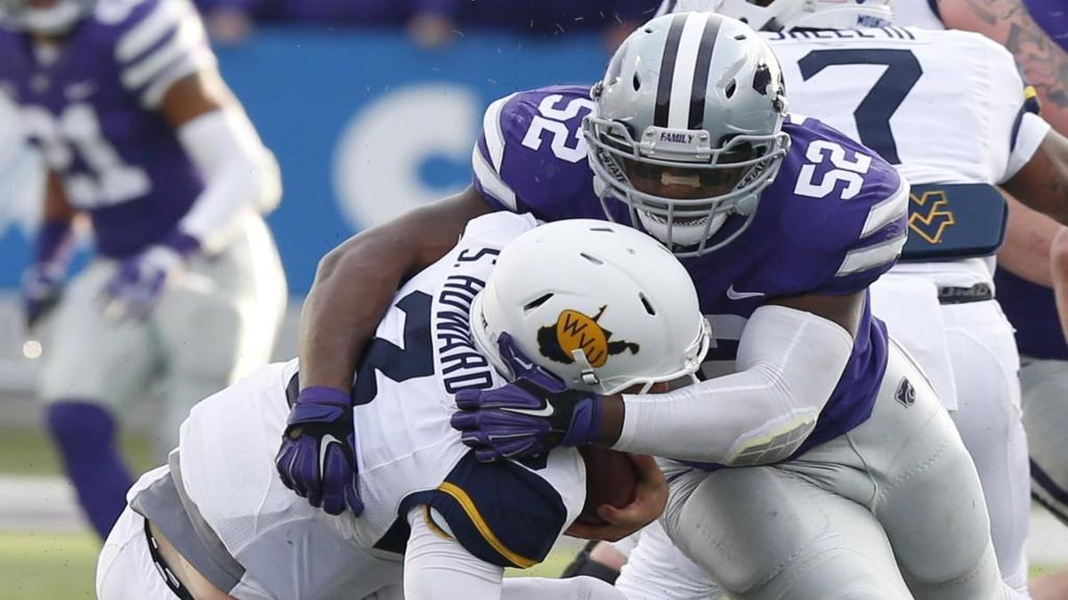 Kansas State linebacker Charmeachealle Moore sacks West Virginia quarterback Skyler Howard in the first quarter Saturday in Manhattan.