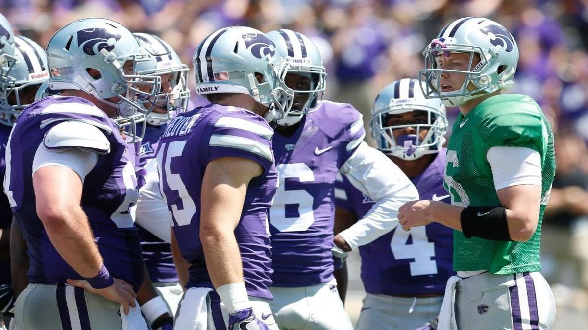 K-State quarterback Jesse Ertz huddles with the purple offense at last year’s spring game. He will miss Saturday’s scrimmage while he recovers from shoulder surgery. (April 23, 2016)
