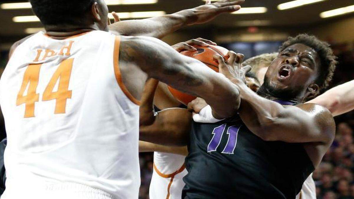 
K-State forward Nino Williams and Texas center Prince Ibeh battle for a rebound in Manhattan. Texas won 61-57 on Feb. 7.
