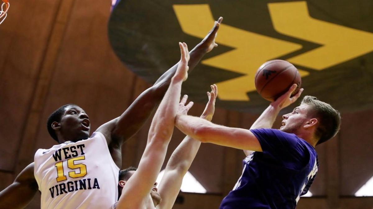 Kansas State forward Dean Wade shoots as West Virginia forward Lamont West, left, defends during the first half Saturday in Morgantown, W.Va.