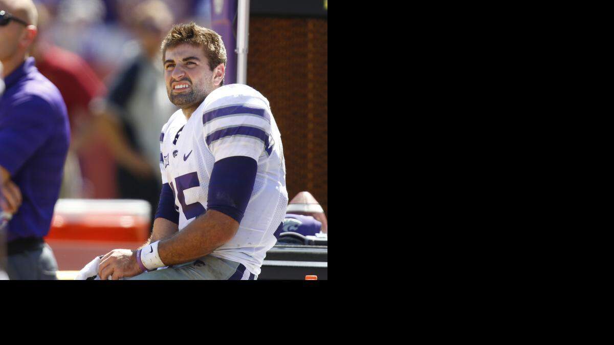 
K-State quarterback Jake Waters (15) sits on the bench Saturday after a hard hit on a two-point conversion as the Wildcats mounted a comeback against Iowa State.
