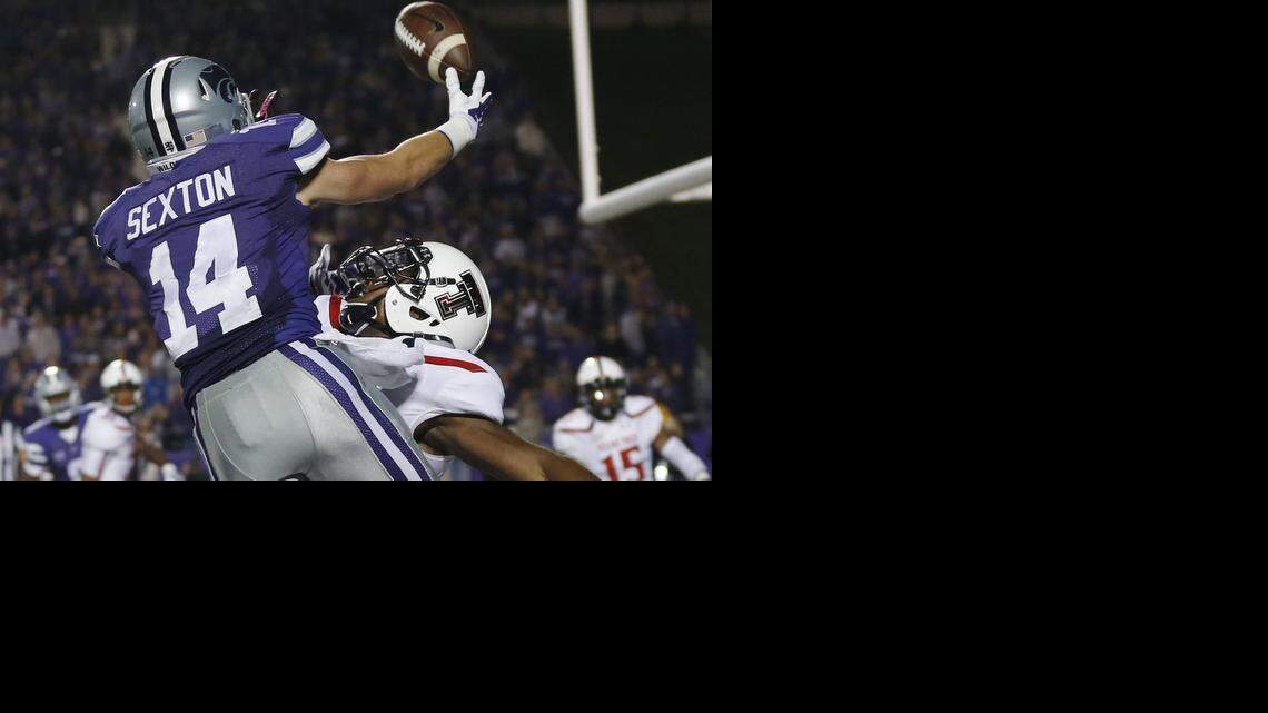 
Kansas State wide receiver Curry Sexton (14) makes a catch for a touchdown while covered by Texas Tech defensive back Austin Stewart, back, during the second half of an NCAA college football game in Manhattan, Kan., Saturday. (Oct. 4, 2014)
