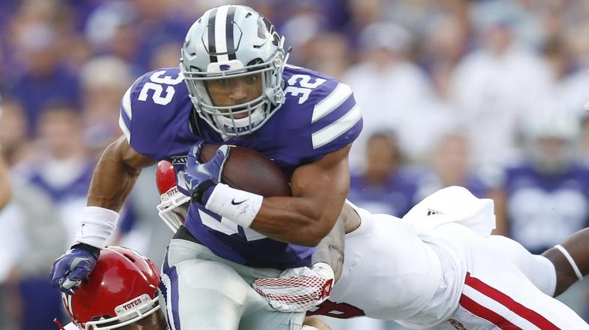 
K-State running back Justin Silmon runs through two South Dakota defenders during a run in the second quarter Saturday night. 
