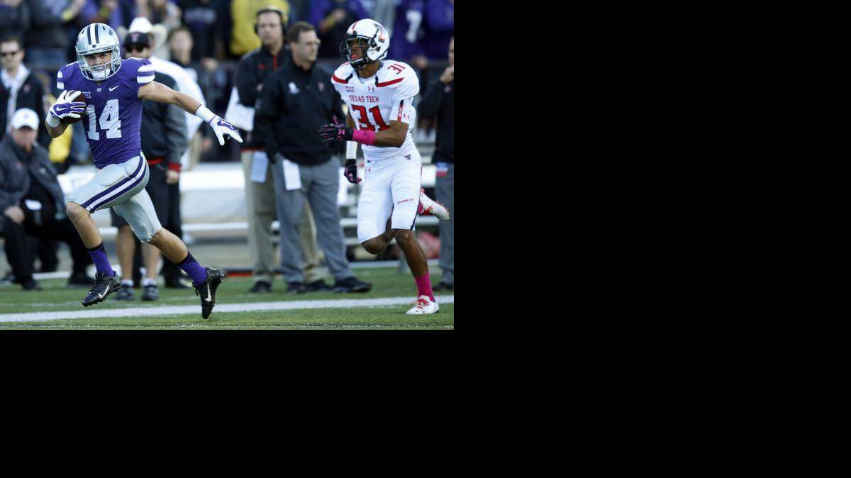 
K-State wide receiver Curry Sexton (14) heads for the goal line after catching a pass from Jake Waters. Sexton's touchdown was the first of the night against Texas Tech.
