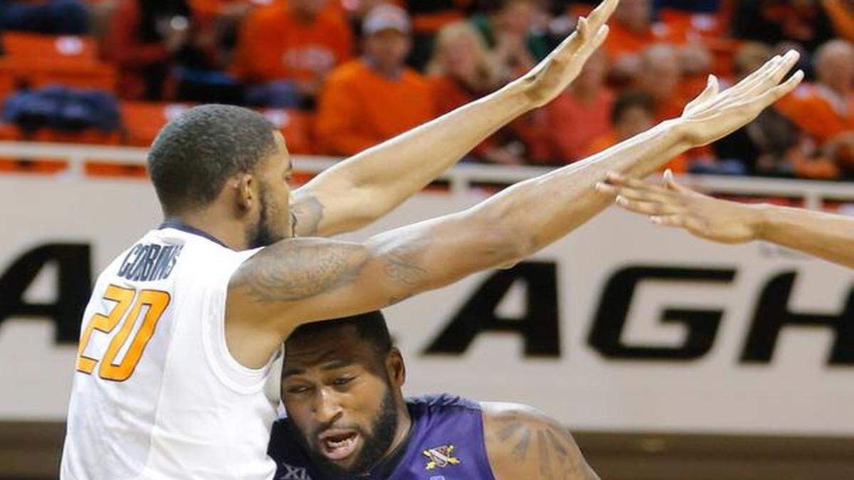 
Kansas State forward Thomas Gipson fights Oklahoma State forward Michael Cobbins under the basket during the second half on Saturday in Stillwater.
