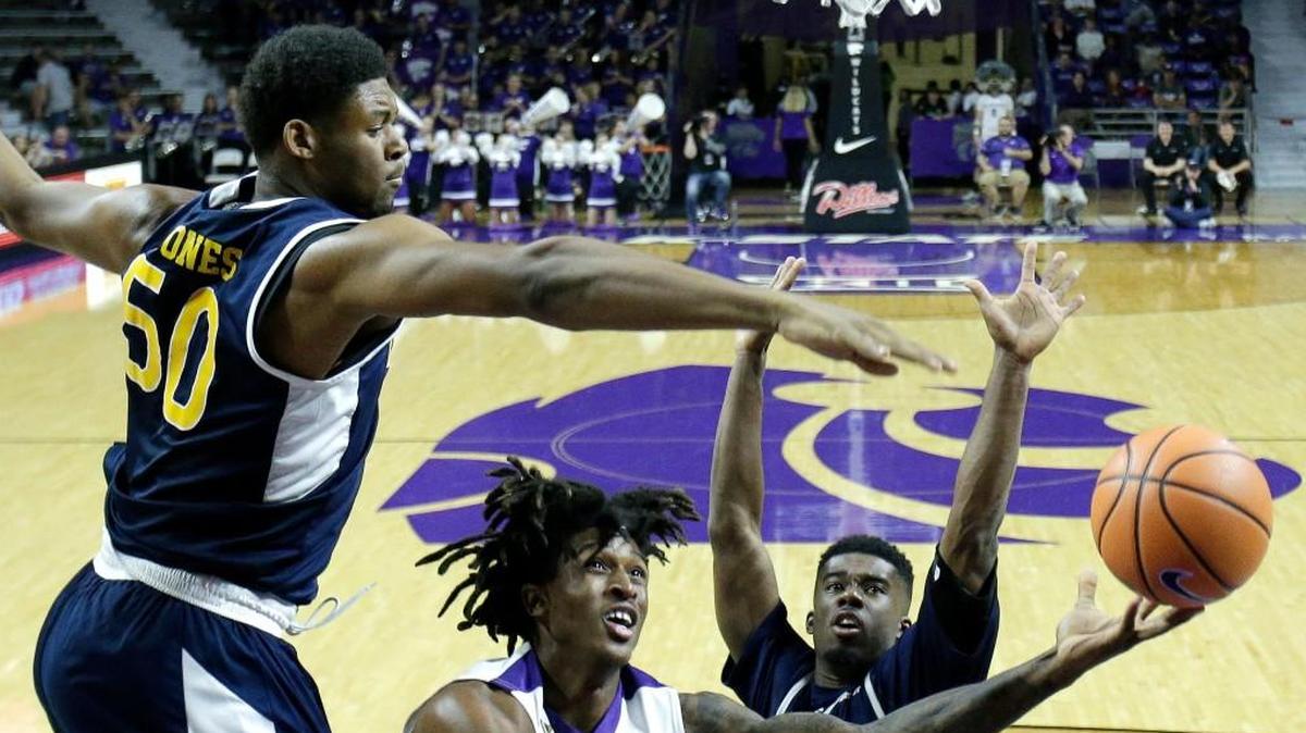 Kansas State's Cartier Diarra, center, shoots under pressure from UC Irvine's Elston Jones, left, and Max Hazzard, right, during the second half Friday in Manhattan.