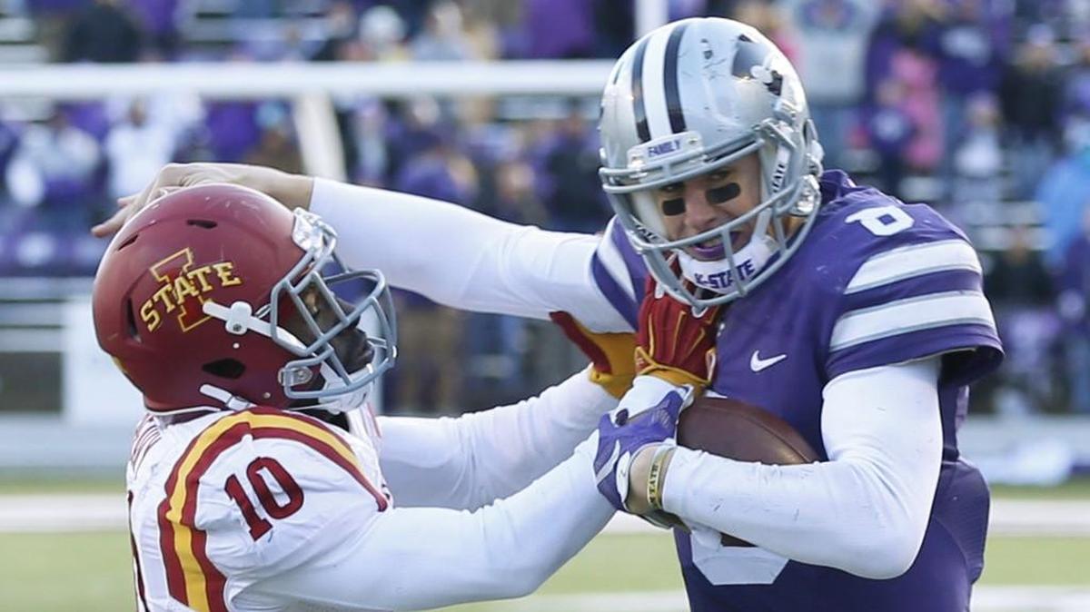 K-State quarterback Joe Hubener stiff arms Iowa State defensive back Brian Peavy during a game in 2015. K-State won that battle 38-35 after trailing 35-14 at halftime.