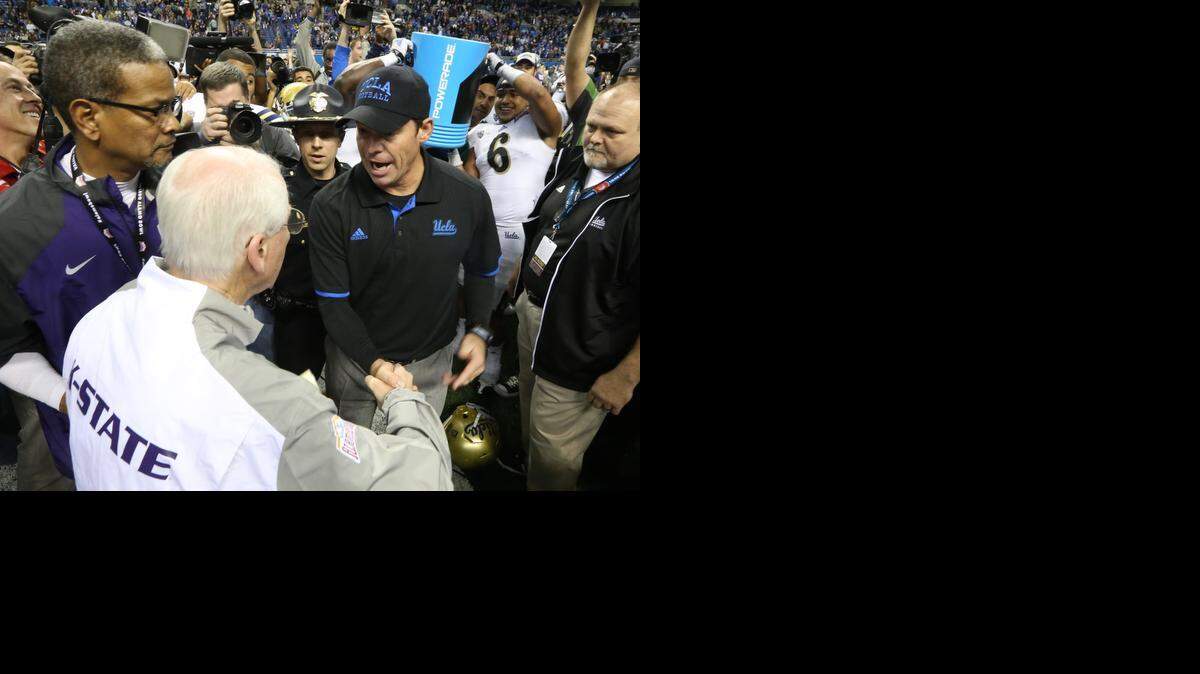 
K-State coach Bill Snyder, shakes hands with UCLA coach Jim Mora after UCLA’s Alamo Bowl victory Friday night. The handshake didn’t last long before Mora was doused with Gatorade.
