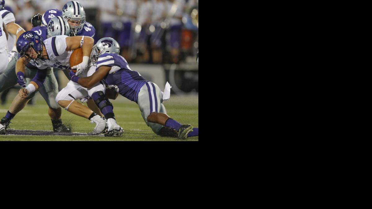 
Kansas State's Randall Evans tackles Stephen F. Austin quarterback Zach Conque during the third quarter of their game on Saturday at Snyder Family Stadium.
