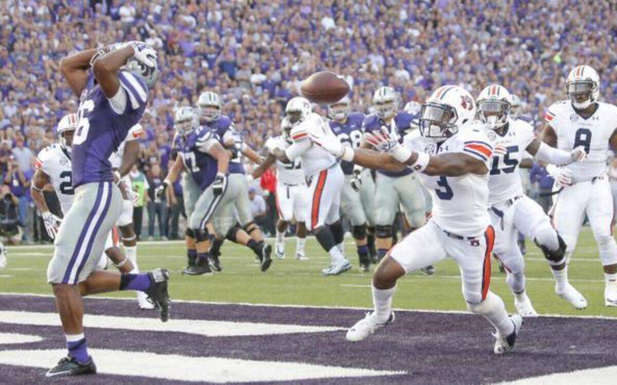 
Auburn defensive back Jonathan Jones intercepts a pass that bounced off the hands of Kansas State wide receiver Tyler Lockett in the end zone during the first half on Thursday night at Snyder Family Stadium in Manhattan.
