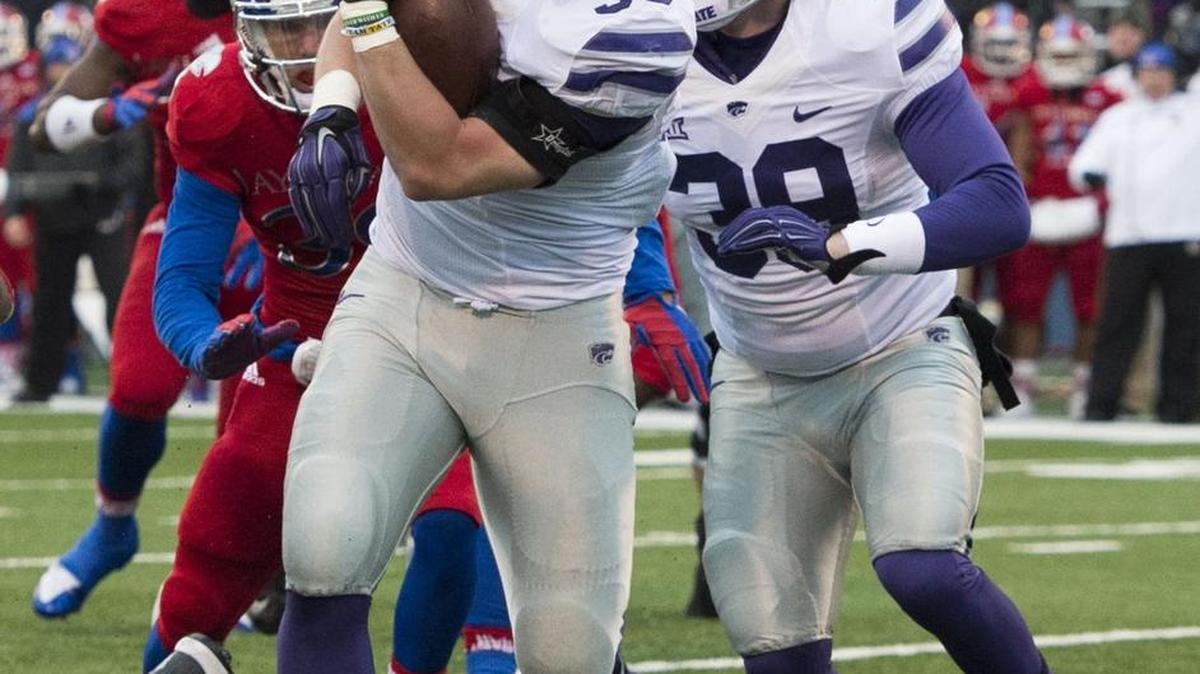 Kansas State Wildcats fullback Winston Dimel fights for more yards in the second quarter during the University of Kansas and Kansas State University Big 12 football game at Memorial Stadium on November 28, 2015 in Lawrence, Kansas.