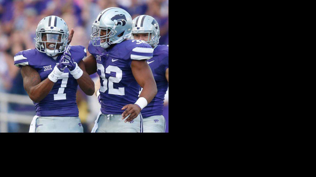 
K-State linebacker Dakorey Johnson (32) and defensive back Danzel McDaniel (7) celebrate after McDaniel broke up an Auburn pass.
