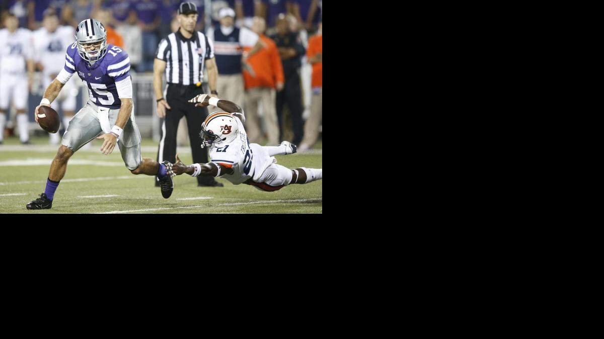 
K-State quarterback Jake Waters (15) looks downfield for a receiver in the second half against Auburn.
