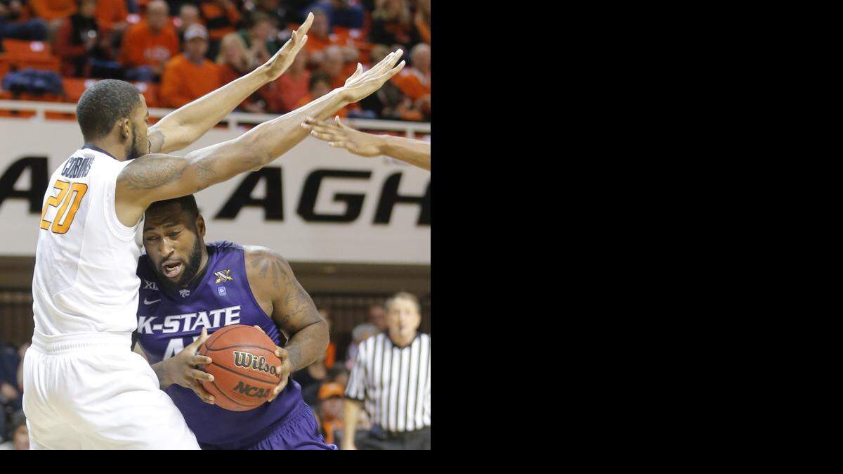 
Kansas State forward Thomas Gipson fights Oklahoma State forward Michael Cobbins under the basket during the second half on Saturday in Stillwater.
