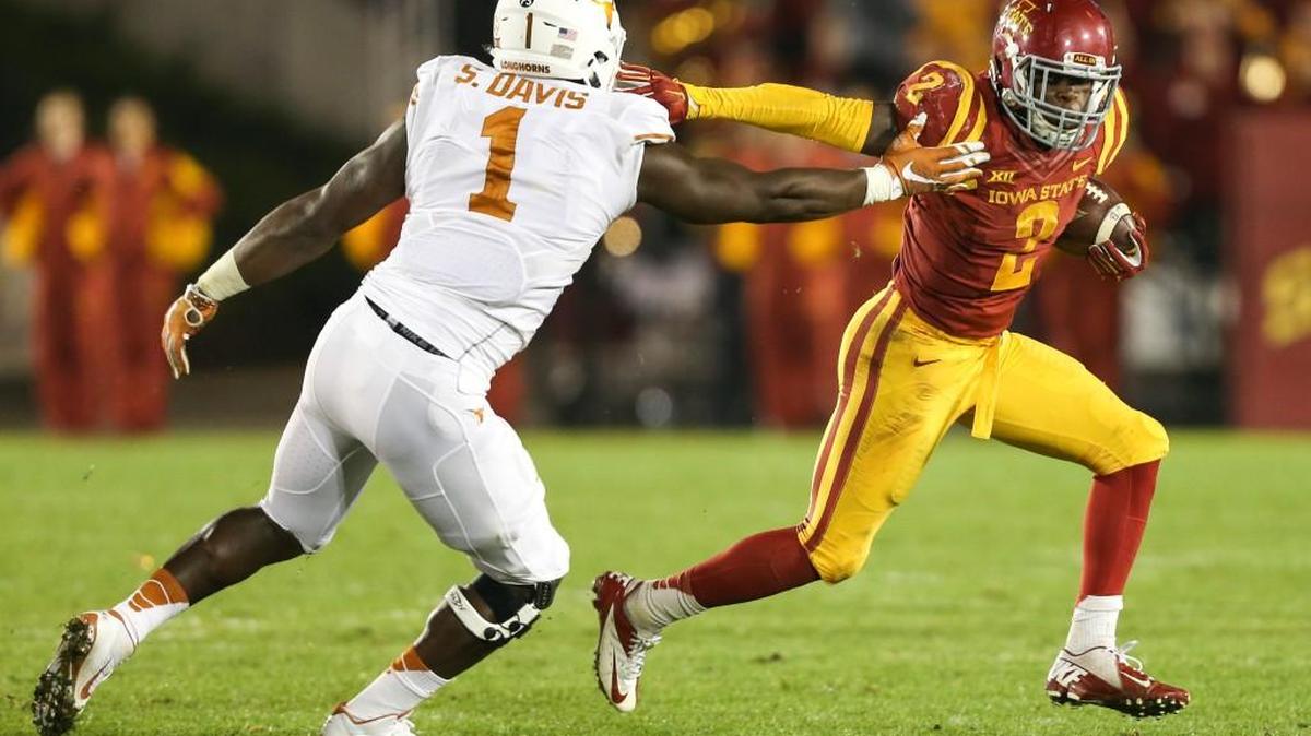 Iowa State running back Mike Warren tries to get around Texas defensive end Shiro Davis, Oct. 31, 2015, in Ames, Iowa. Iowa State won 24-0. (AP Photo/Justin Hayworth)