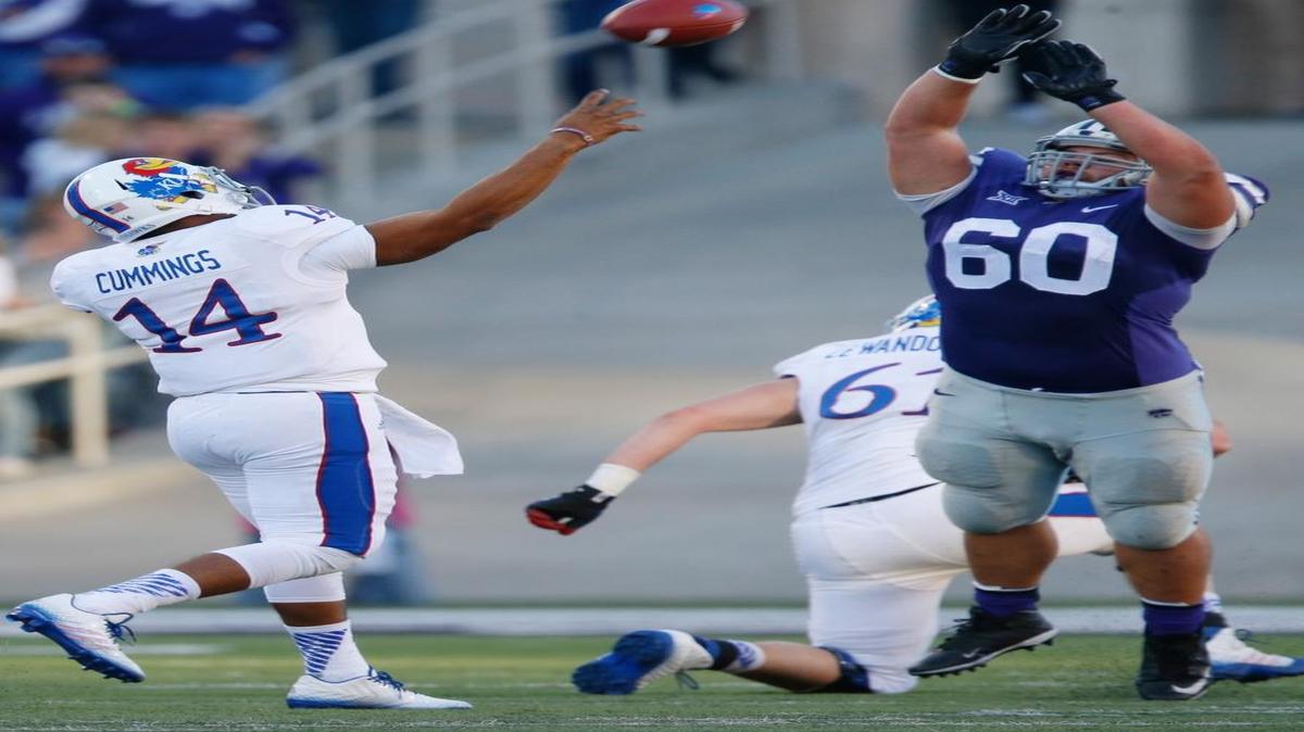 
Will Geary (60) tries to block a pass by Kansas quarterback Michael Cummings last November in Manhattan.
