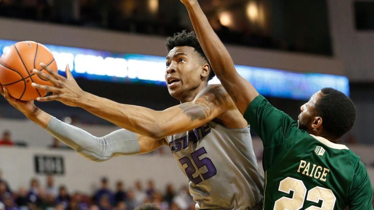 K-State forward Wesley Iwundu puts up a shot around Colorado State guard Jeremiah Paige (22) in the second half Saturday afternoon as K-State defeated Colorado State 61-56.(AP PHOTO/Bo Rader, The Wichita Eagle)