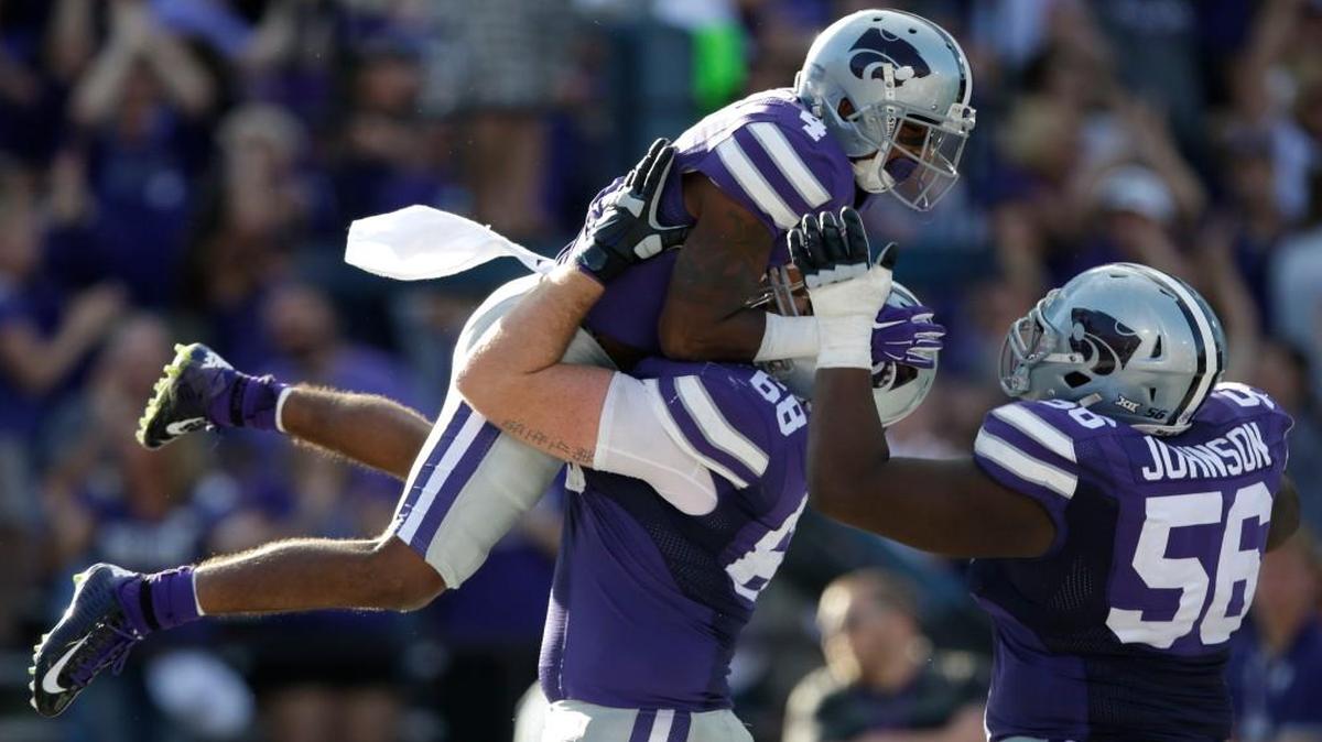 
Kansas State wide receiver Dominique Heath (4) celebrates a touchdown with teammates Luke Hayes (68) and Terrale Johnson (56) during overtime against Louisiana Tech on Sept. 19. 

