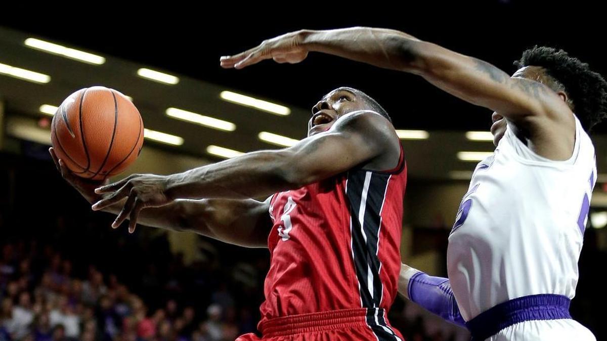 South Dakota's Shy McClelland gets past Kansas State's Wesley Iwundu (25) to put up a shot during the first half Friday in Manhattan.