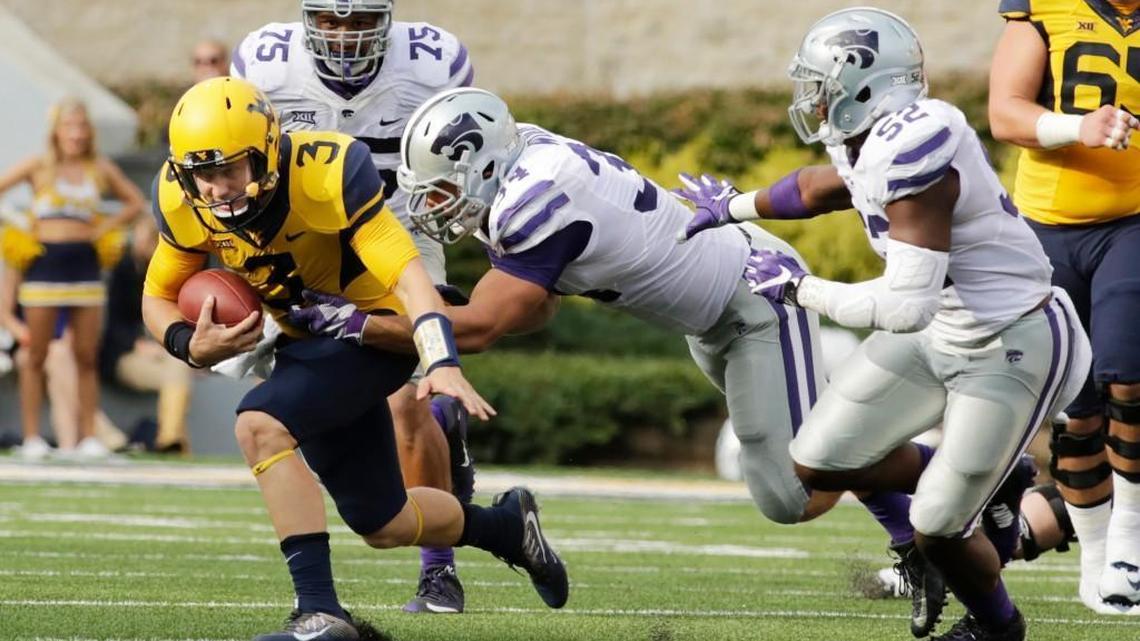 West Virginia quarterback Skyler Howard (3) is tackled by Kansas State defensive end Tanner Wood (34) during the first half.