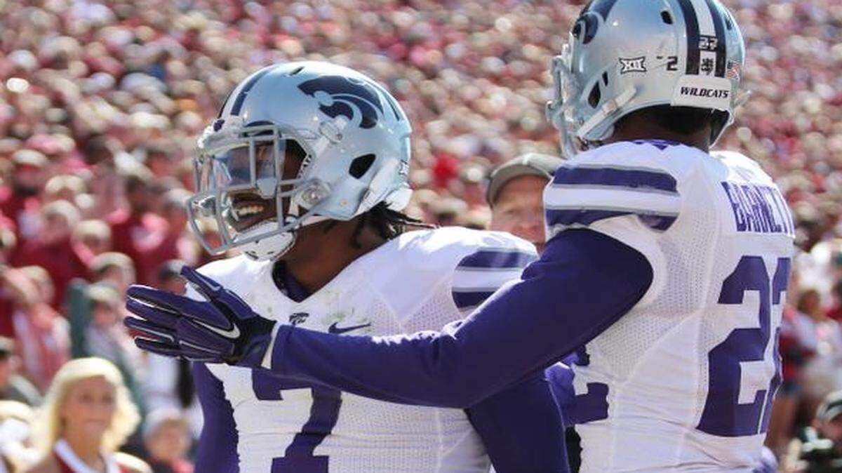 
K-State defensive backs Danzel McDaniel, left, and Dante Barnett celebrate McDaniel’s interception and touchdown against Oklahoma.

