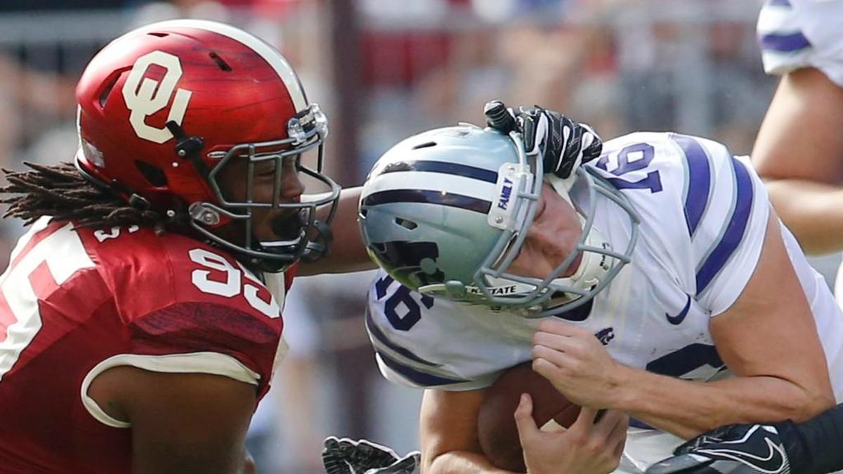 Oklahoma defensive end Austin Roberts snags K-State quarterback Jesse Ertz by the helmet.