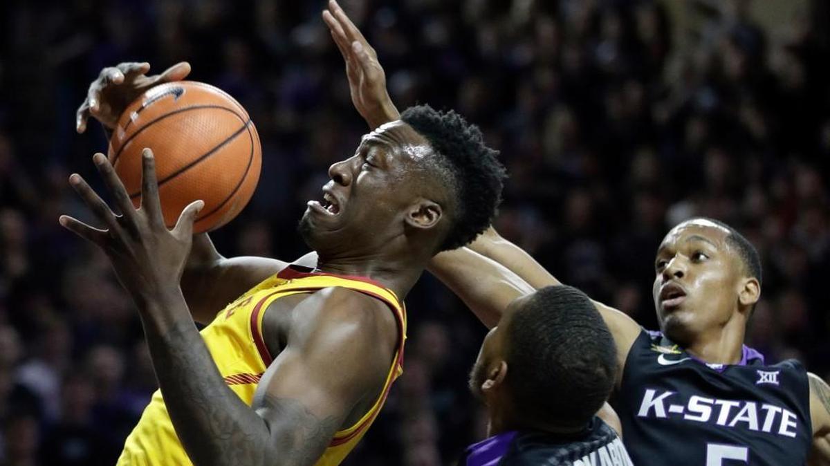 Iowa State forward Cameron Lard rebounds against Kansas State’s Levi Stockard, middle, and Barry Brown during the first half Saturday in Manhattan.