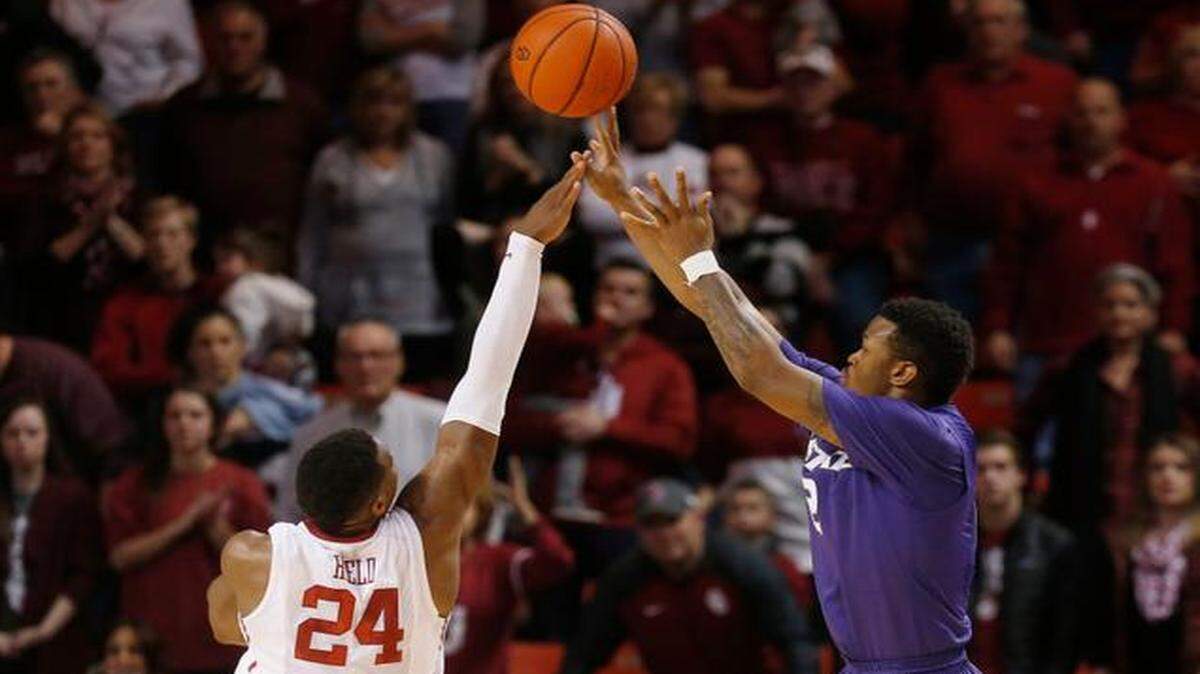
Kansas State guard Marcus Foster, right, shoots the game-winning three-pointer against Oklahoma on Saturday night in Norman.
