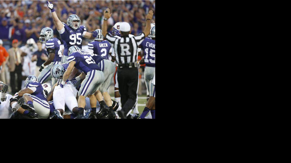
K-State defensive lineman Travis Britz signals K-State recovery of the ball on an Auburn pass play.
