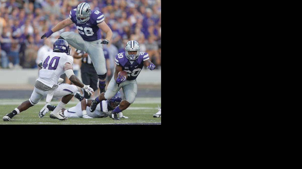
Kansas State's DeMarcus Robinson avoids Stephen F. Austin's Collin Garrett during the second quarter Saturday.
