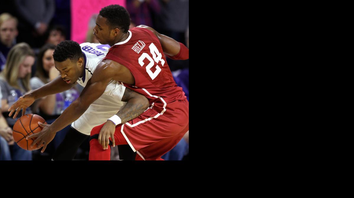 
Oklahoma guard Buddy Hield (24) knocks the ball away from Kansas State guard Marcus Foster (2) during the first half Saturday in Manhattan.
