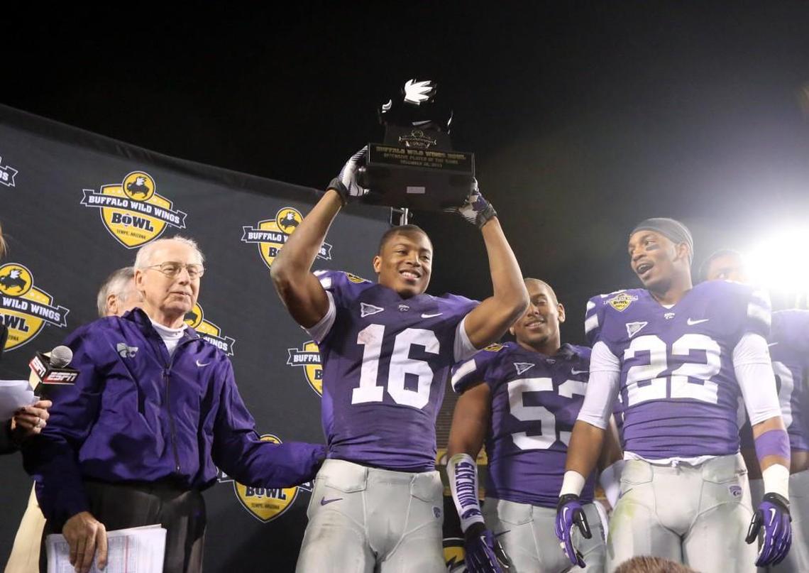K-State football players Dante Barnett (right) and Tyler Lockett celebrate with coach Bill Snyder after the Buffalo Wild Wings Bowl in 2013.