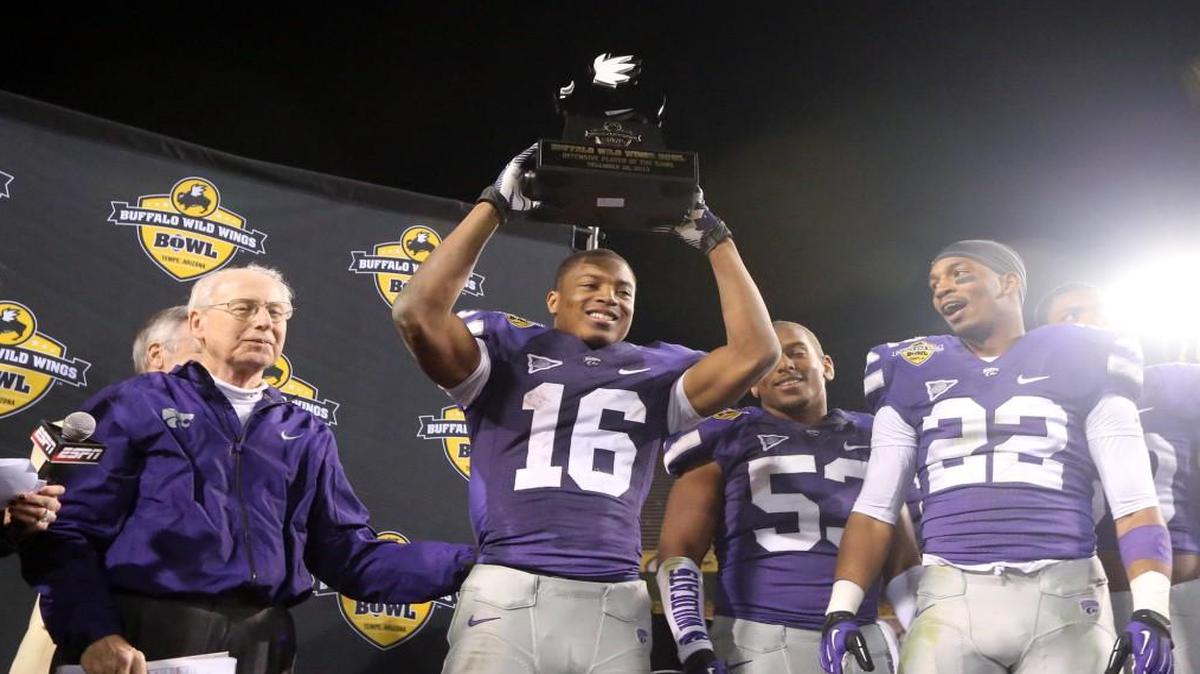 K-State football players Dante Barnett (right) and Tyler Lockett celebrate with coach Bill Snyder after the Buffalo Wild Wings Bowl in 2013.